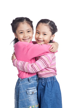 Asian twin sisters hug each other with loveの写真素材