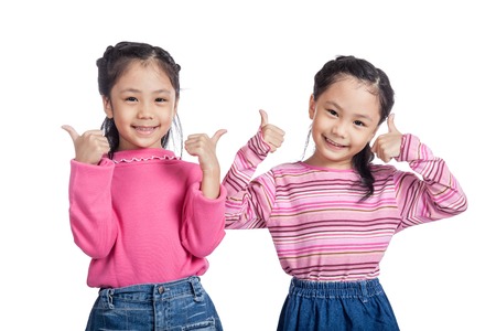 Asian twin sisters show thumbs upの写真素材