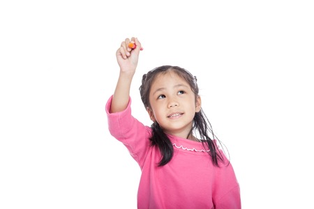 Asian little girl draw with crayon in the air isolated on white backgroundの写真素材