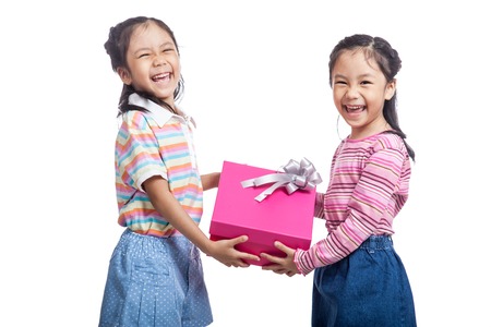 Asian twin sisters very happy hold a gift box  isolated on white backgroundの写真素材
