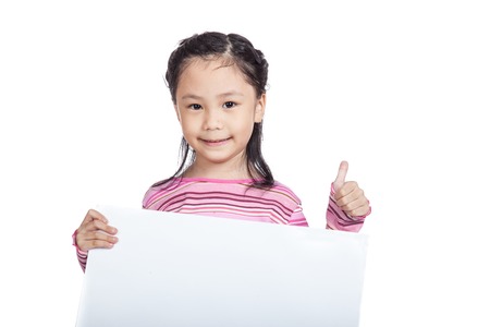 Asian little girl hold a blank board show thumbs up isolated on white backgroundの写真素材