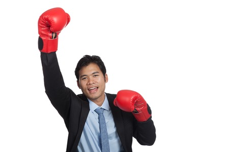 Asian businessman win fight fist pump for success isolated on white backgroundの写真素材