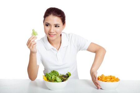 Asian girl smile for salad push away crisps  isolated on white backgroundの写真素材