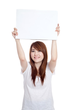 Happy Asian girl show  blank sign over head  isolated on white backgroundの写真素材