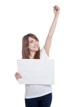 Asian girl hold blank sign fist up isolated on white backgroundの写真素材