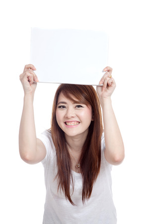 Asian girl hold blank sign over head with both hand  isolated on white backgroundの写真素材