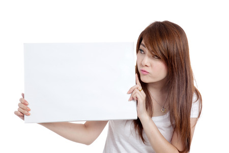 Asian girl bore look at  blank sign  isolated on white backgroundの写真素材