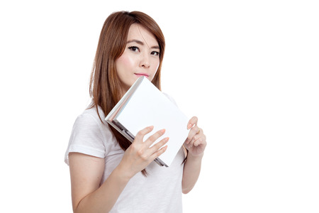 Asian girl hold a book look at camera  isolated on white backgroundの写真素材