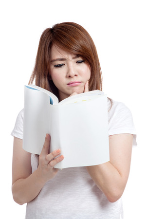Asian girl think and reading book  isolated on white backgroundの写真素材