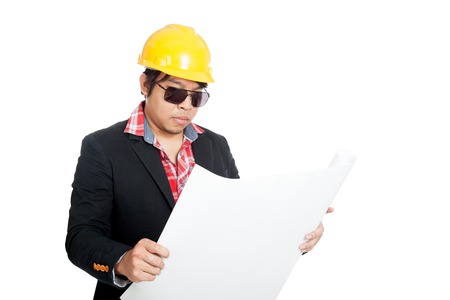 Asian engineer man read blueprint  isolated on white backgroundの写真素材