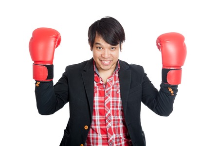 Asian man wear suit show boxing gloves and smile  isolated on white backgroundの写真素材