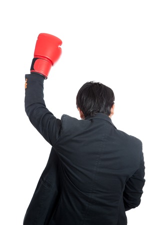 Back of Asian man wear boxing glove raise hand up  isolated on white backgroundの写真素材