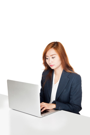 Asian office girl working on labtop  isolated on white backgroundの写真素材