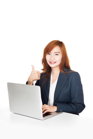Asian office girl show thumbs up with notebook PC  isolated on white backgroundの写真素材