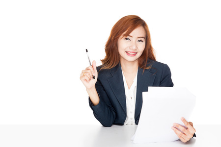 Asian office girl reading document and smile  isolated on white backgroundの写真素材