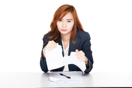 Asian office girl unhappy tear paper  isolated on white backgroundの写真素材