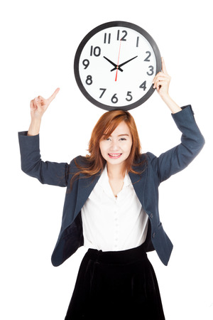 Asian businesswoman point to clock over head  isolated on white backgroundの写真素材