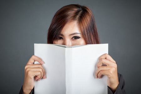 Close up of Asian business girl hold a book on gray backgroundの写真素材