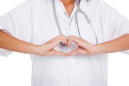 Doctor show heart hand sign  isolated on white backgroundの写真素材