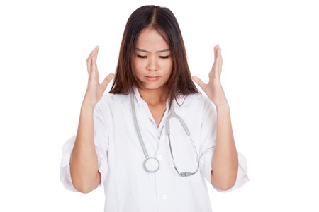 Frustrated Asian young female doctor  isolated on white backgroundの写真素材