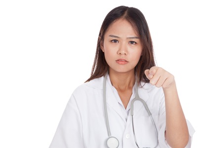Asian young female doctor upset  point to camera  isolated on white backgroundの写真素材