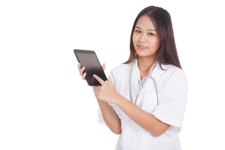 Asian young female doctor smile touch tablet pc  isolated on white backgroundの写真素材