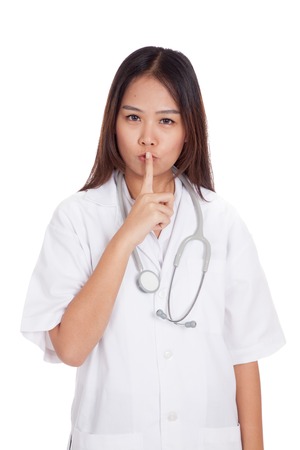 Asian young female doctor do quiet sign  isolated on white backgroundの写真素材