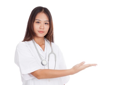 Asian young female doctor present something on her left  isolated on white backgroundの写真素材