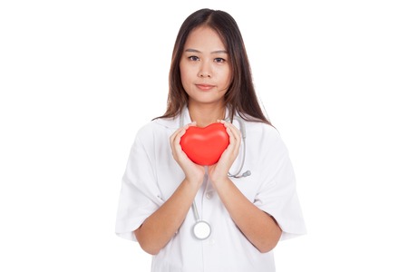 Asian young female doctor hold a red heart  isolated on white backgroundの写真素材