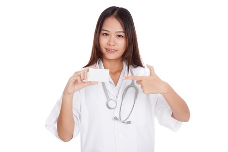 Asian young female doctor point to blank card  isolated on white backgroundの写真素材