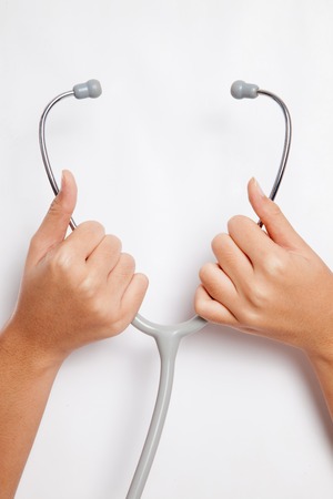 Hands  hold stethoscope  on white backgroundの写真素材