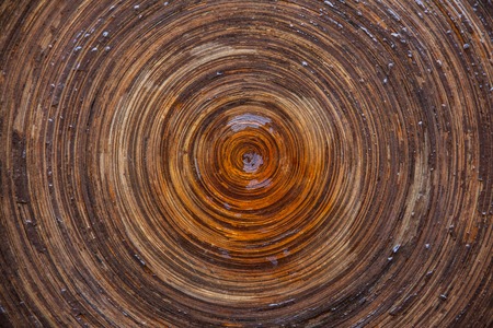 Close up of circular texture of wet  wood table topの写真素材