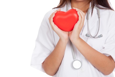 Close up of Asian female doctor hold a red heart and  isolated on white backgroundの写真素材