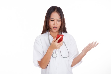 Asian young doctor woman upset with  mobile phone  isolated on white backgroundの写真素材