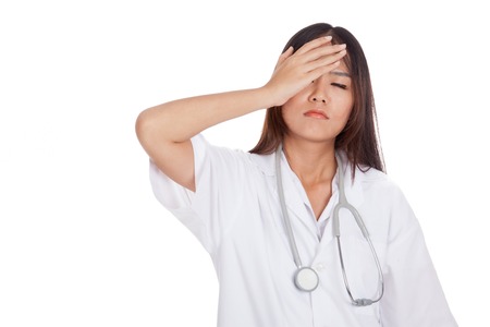 Asian young  female doctor got headache  isolated on white backgroundの写真素材