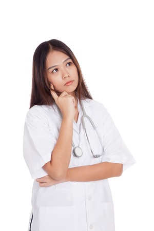 Asian young female doctor thinking looking up  isolated on white backgroundの写真素材