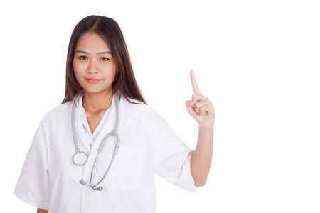 Asian young female doctor point up  isolated on white backgroundの写真素材