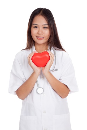 Asian young female doctor hold a red heart and smile  isolated on white backgroundの写真素材