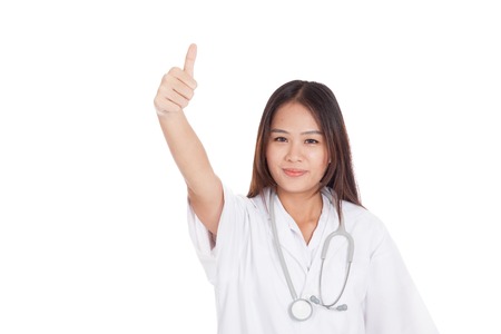 Young Asian female doctor show thumbs up  isolated on white backgroundの写真素材