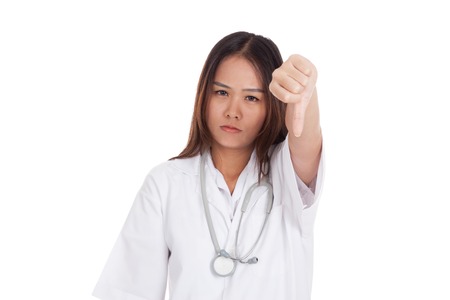 Young Asian female doctor angry show thumbs down  isolated on white backgroundの写真素材