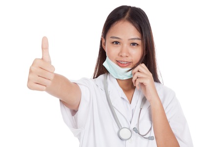 Young Asian female doctor pull mask and show thumbs up  isolated on white backgroundの写真素材
