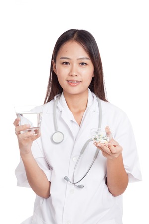Young Asian female doctor with water and medicine  isolated on white backgroundの写真素材