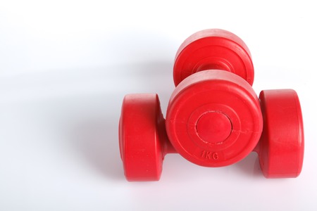 Red dumbbells weight isolated on white backgroundの写真素材