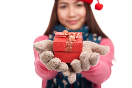 Asian girl with winter dress and gift box focus at box  isolated on white backgroundの写真素材