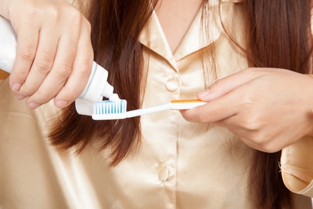 Close up of  Asian woman hands with toothbrush and toothpasteの写真素材