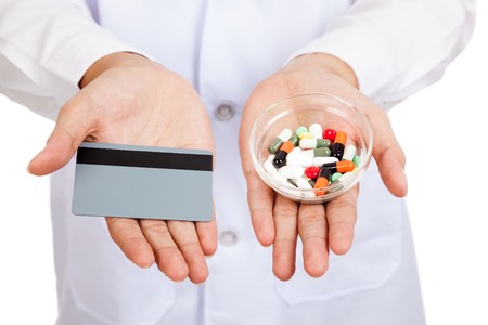 Close up of Asian male doctor show a card with pillsの写真素材