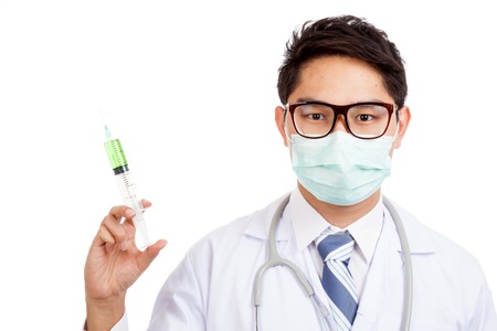 Asian male doctor wear mask with syringe  isolated on white backgroundの写真素材