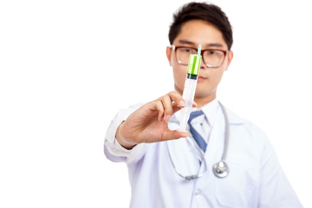 Asian male doctor hold syringe with green medicine  isolated on white backgroundの写真素材