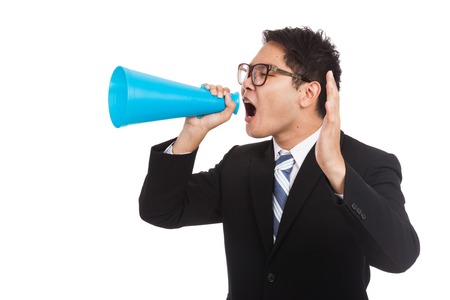 Asian businessman shout with megaphone  isolated on white backgroundの写真素材