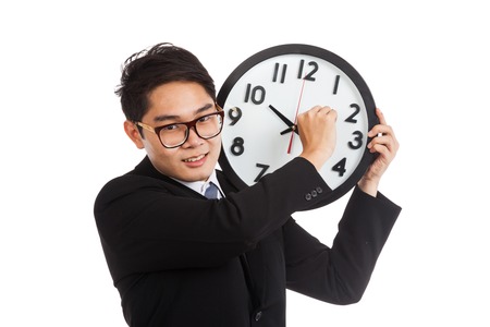 Asian businessman smile move clock arm  isolated on white backgroundの写真素材